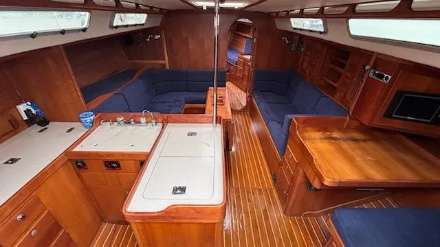 Slide: The Image of Interior of 2003 J Boats J/46 sailboat with wood finish and blue seating. - 29