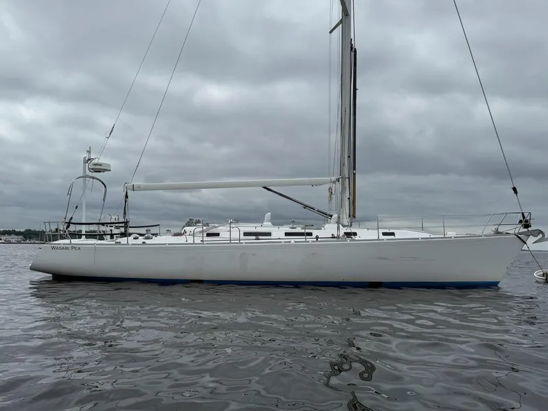 The Image of 2003 J Boats J/46 sailboat on calm water under cloudy skies. - 3