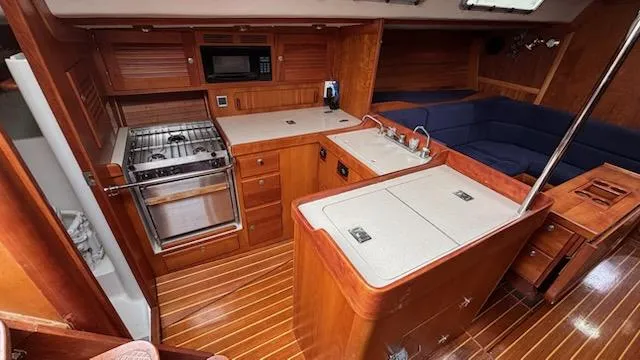 Slide: The Image of 2003 J Boats J/46 yacht interior with kitchen and seating area. - 31