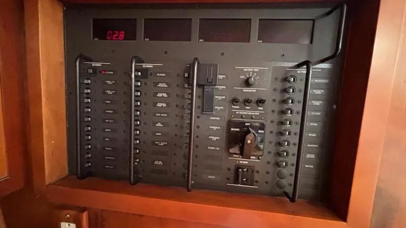 Slide: The Image of Electrical panel of a 2003 J Boats J/46 sailboat, featuring switches and controls. - 38