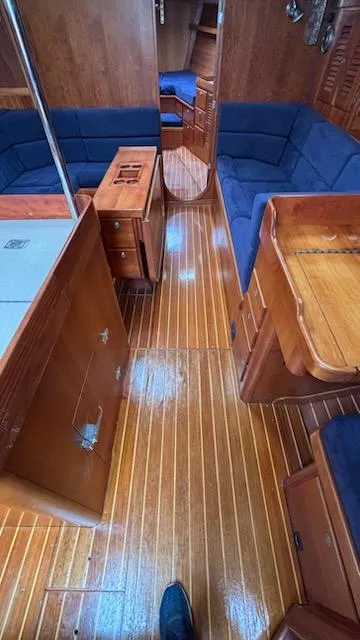 Slide: The Image of Interior of 2003 J Boats J/46 sailboat with wooden flooring and blue seating. - 41