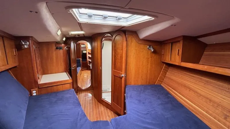 Slide: The Image of Interior of 2003 J Boats J/46 yacht with wooden finish and blue upholstery. - 45