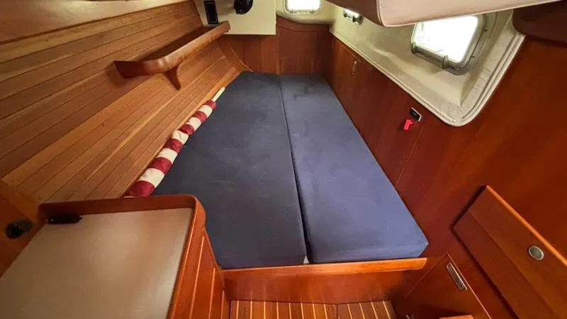 Slide: The Image of Interior cabin of 2003 J Boats J/46 with wooden paneling and blue cushions. - 46