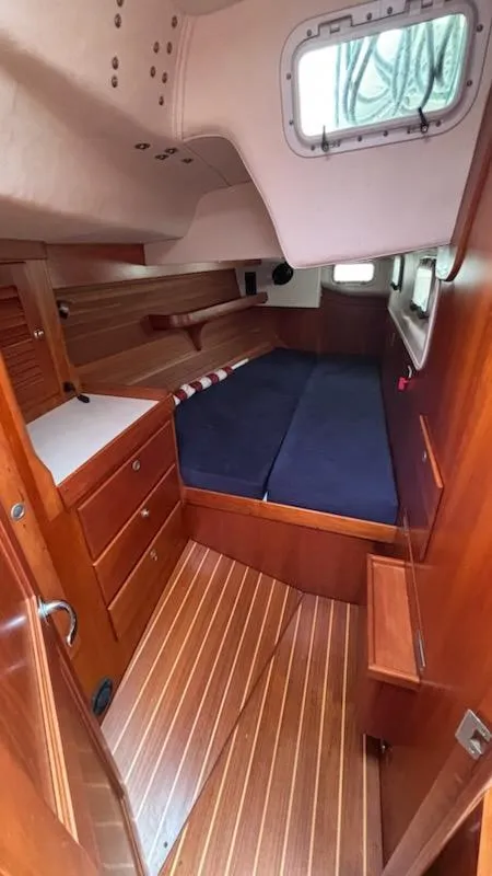 Slide: The Image of 2003 J Boats J/46 cabin interior with wooden finish and blue bedding. - 47