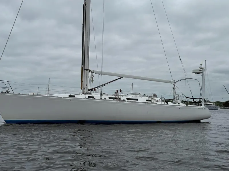 Slide: The Image of 2003 J Boats J/46 sailboat on calm water under cloudy skies. - 5