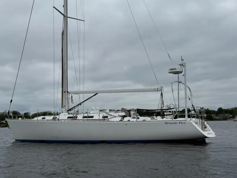 Slide: The Image of 2003 J Boats J/46 sailboat on calm water under cloudy skies. - 6