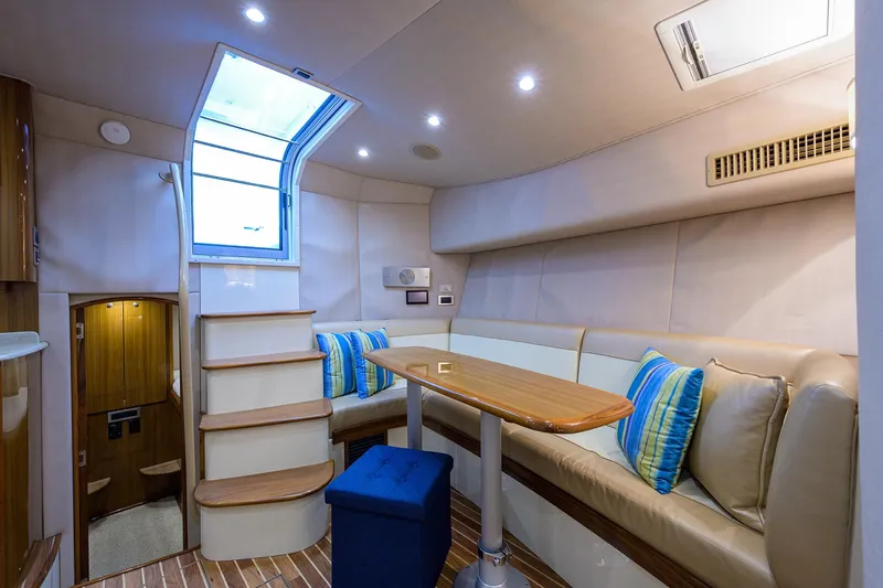 Slide: The Image of Interior of 2013 Viking 42 Open yacht with seating, table, and skylight. - 11