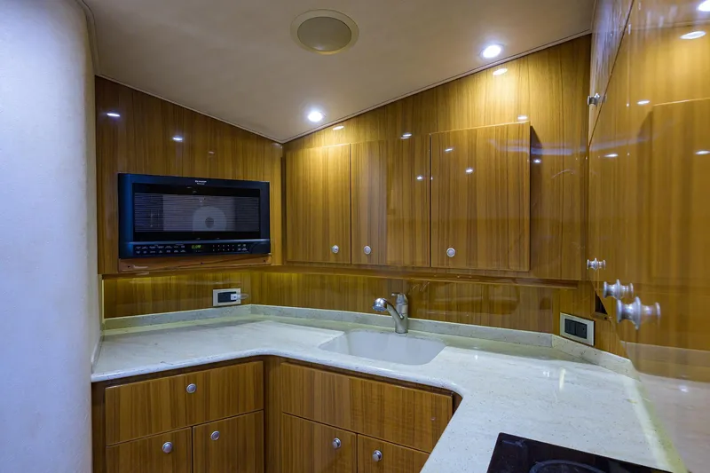 Slide: The Image of Luxurious kitchen interior of 2013 Viking 42 Open yacht with wood cabinetry and modern appliances. - 15
