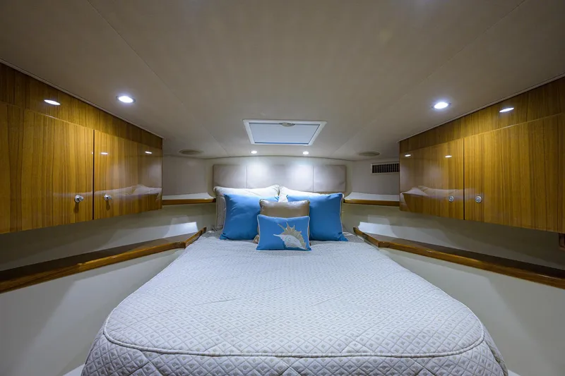 Slide: The Image of Luxurious cabin interior of 2013 Viking 42 Open yacht with cozy bedding and wooden cabinets. - 16
