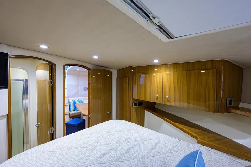 Slide: The Image of Luxurious interior of 2013 Viking 42 Open yacht with wood finish and cozy bedding. - 18