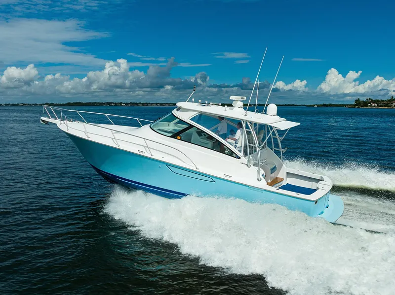 Slide: The Image of 2013 Viking 42 Open yacht cruising on open water under a clear blue sky. - 22