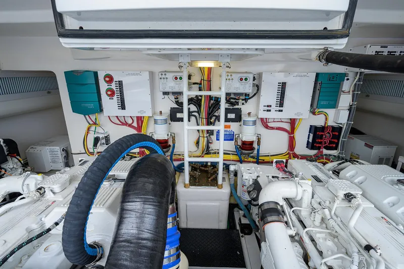 Slide: The Image of Engine room of 2013 Viking 42 Open yacht, showcasing complex machinery and wiring. - 26