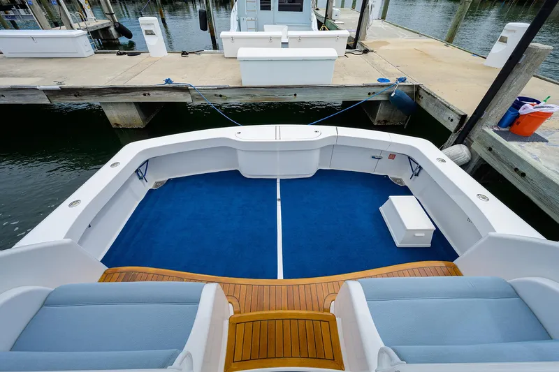 Slide: The Image of 2013 Viking 42 Open yacht with blue deck and wooden accents at a marina. - 3