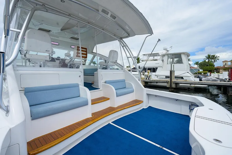 Slide: The Image of 2013 Viking 42 Open yacht with blue seating and deck, docked at marina. - 4