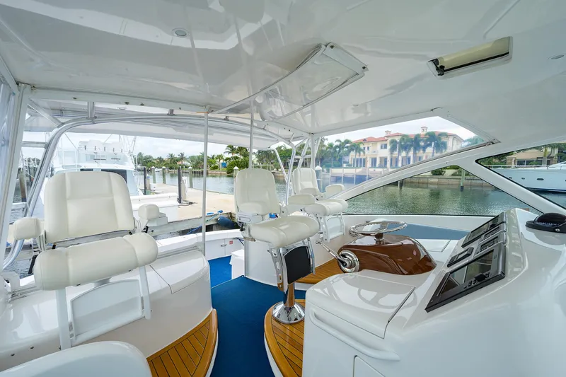 Slide: The Image of 2013 Viking 42 Open yacht interior with white seating and modern helm. - 9