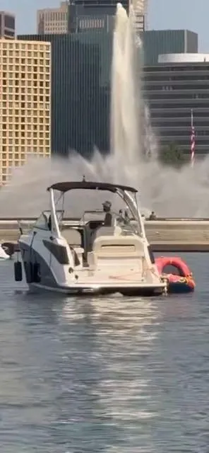 The Image of 2024 Regal 26 X boat on water near cityscape and fountain. - 0