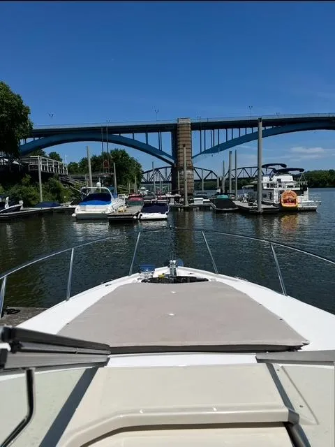 Slide: The Image of 2024 Regal 26 X boat docked near a bridge on a sunny day. - 12