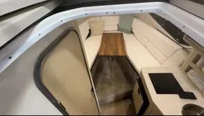 Slide: The Image of 2024 Regal 26 X cabin interior with seating, table, and kitchenette. - 6