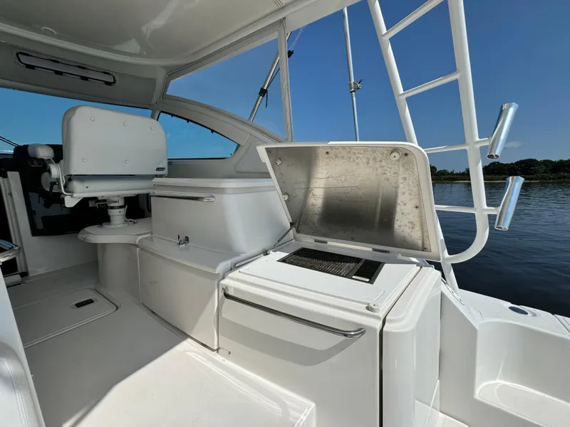 Slide: The Image of 2019 Tiara Yachts 4300 Open interior with seating and open storage, under clear blue sky. - 10