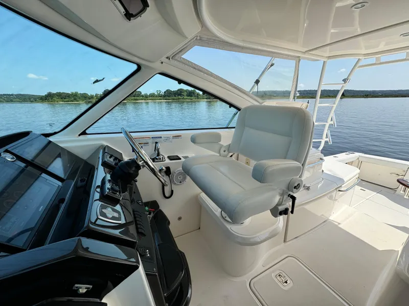 Slide: The Image of 2019 Tiara Yachts 4300 Open helm with luxurious seating and panoramic water views. - 13