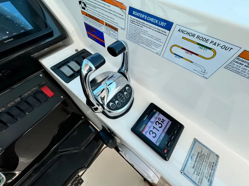 Slide: The Image of Helm controls of 2019 Tiara Yachts 4300 Open, featuring throttle and digital display. - 16