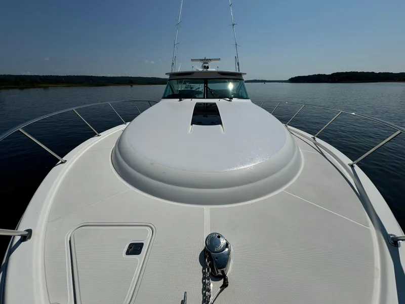 Slide: The Image of 2019 Tiara Yachts 4300 Open on calm water, showcasing sleek deck design. - 18