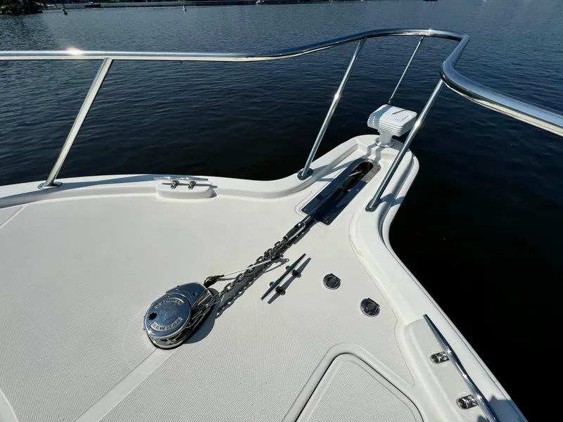 Slide: The Image of Bow of 2019 Tiara Yachts 4300 Open, featuring anchor chain and railing over water. - 19