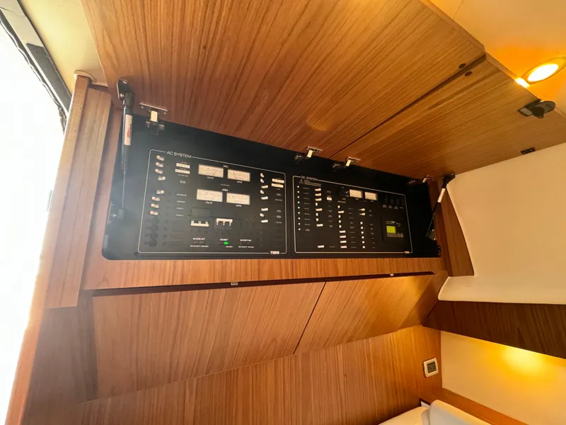 Slide: The Image of Control panel inside 2019 Tiara Yachts 4300 Open, featuring wood paneling and modern design. - 23