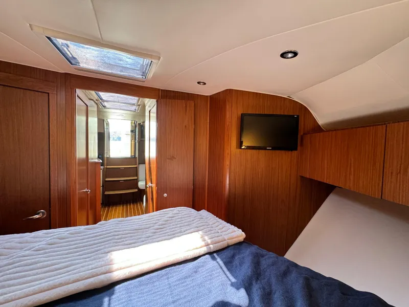 Slide: The Image of 2019 Tiara Yachts 4300 Open cabin interior with wood paneling and skylight. - 28