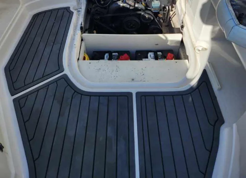 Slide: The Image of 2013 Monterey 264FSX boat engine compartment with black non-slip flooring. - 10