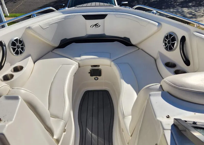 Slide: The Image of 2013 Monterey 264FSX boat interior with white seating and speaker system. - 2