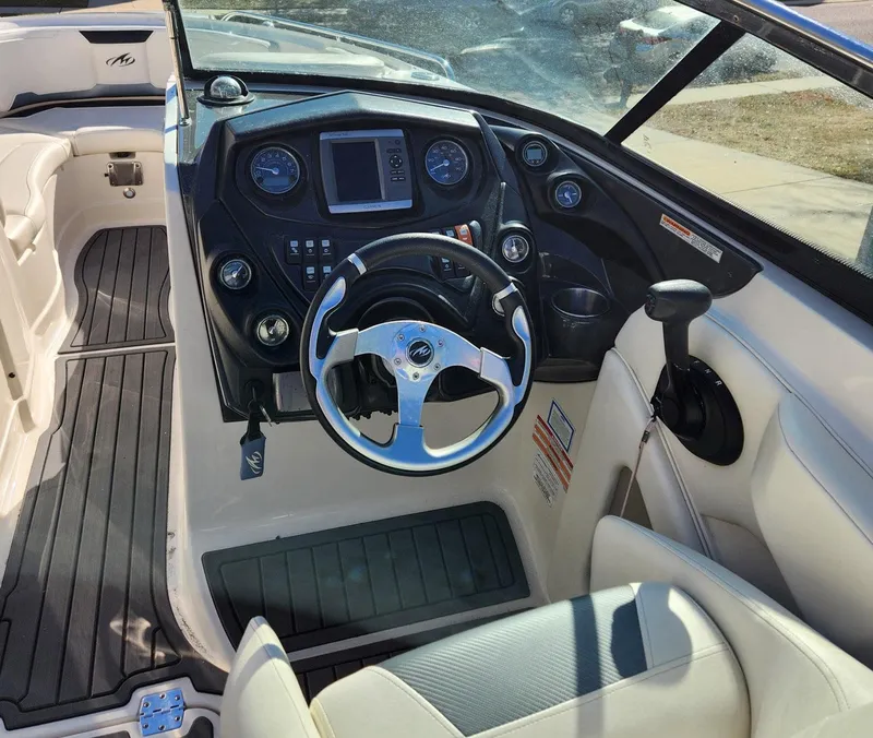Slide: The Image of 2013 Monterey 264FSX boat cockpit with steering wheel and control panel. - 6