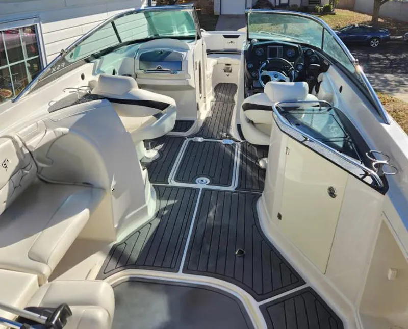 Slide: The Image of 2013 Monterey 264FSX boat interior with sleek seating and modern dashboard. - 7