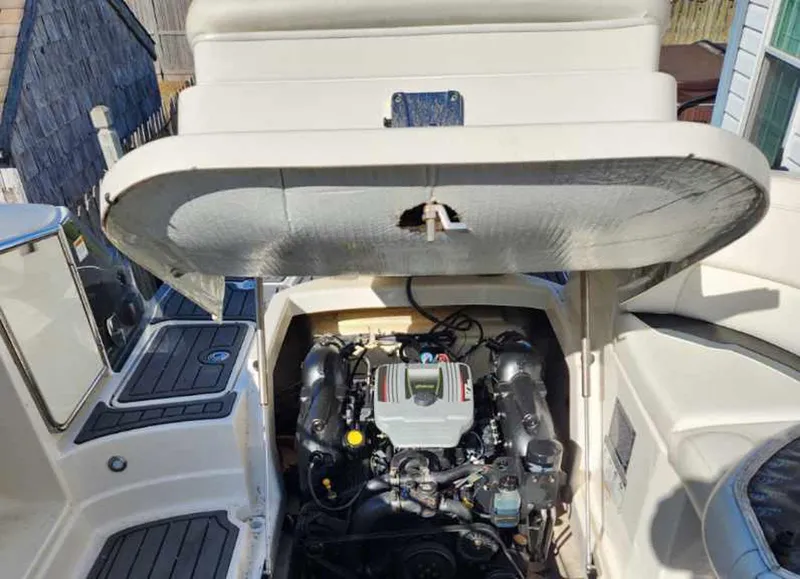 Slide: The Image of 2013 Monterey 264FSX boat engine compartment with open hatch, showcasing engine details. - 8