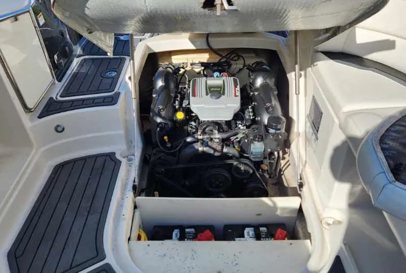 Slide: The Image of Engine compartment of a 2013 Monterey 264FSX boat, showcasing the engine and surrounding area. - 9