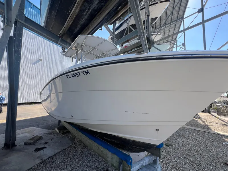 Slide: The Image of 2023 Cobia 237 Center Console boat in storage, side view. - 10