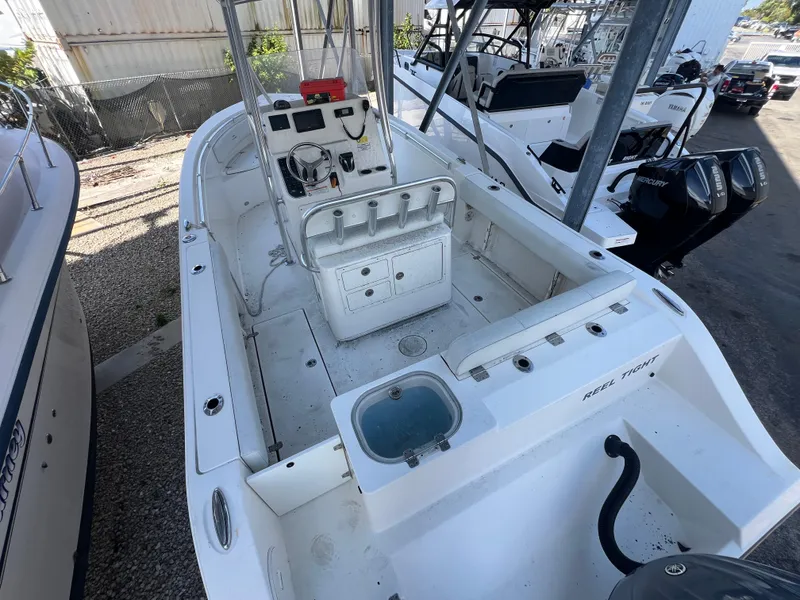 Slide: The Image of 2023 Cobia 237 Center Console boat with spacious deck and modern controls. - 3