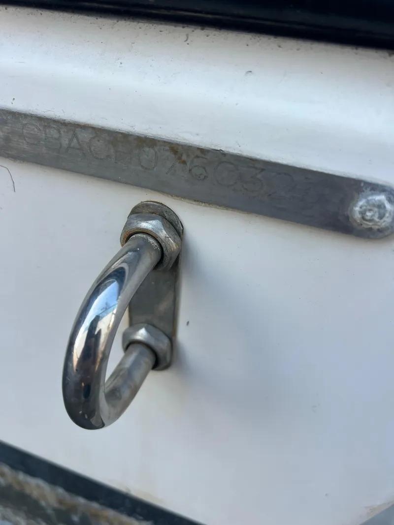 Slide: The Image of Close-up of a 2023 Cobia 237 Center Console boat's metal hook and plate. - 5