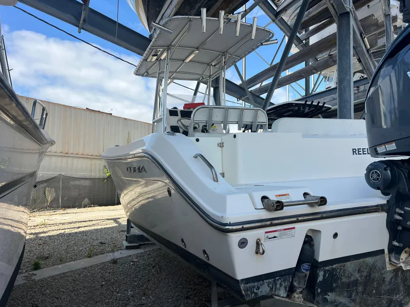 Slide: The Image of 2023 Cobia 237 Center Console boat in storage, rear view. - 8