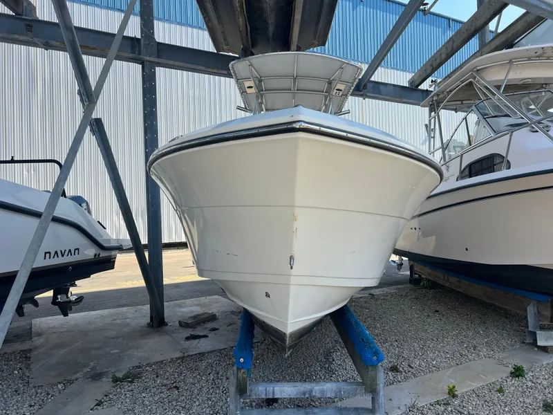 Slide: The Image of 2023 Cobia 237 Center Console boat in storage, front view. - 9