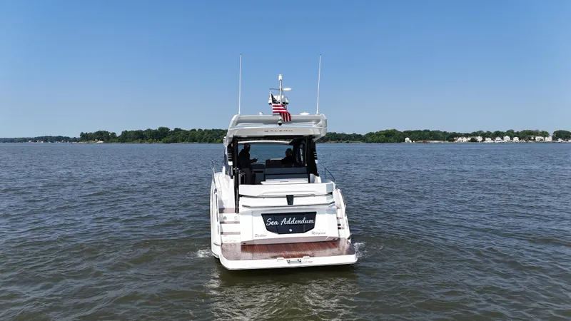 Slide: The Image of 2021 Galeon 425 HTS yacht cruising on a calm lake under a clear blue sky. - 10