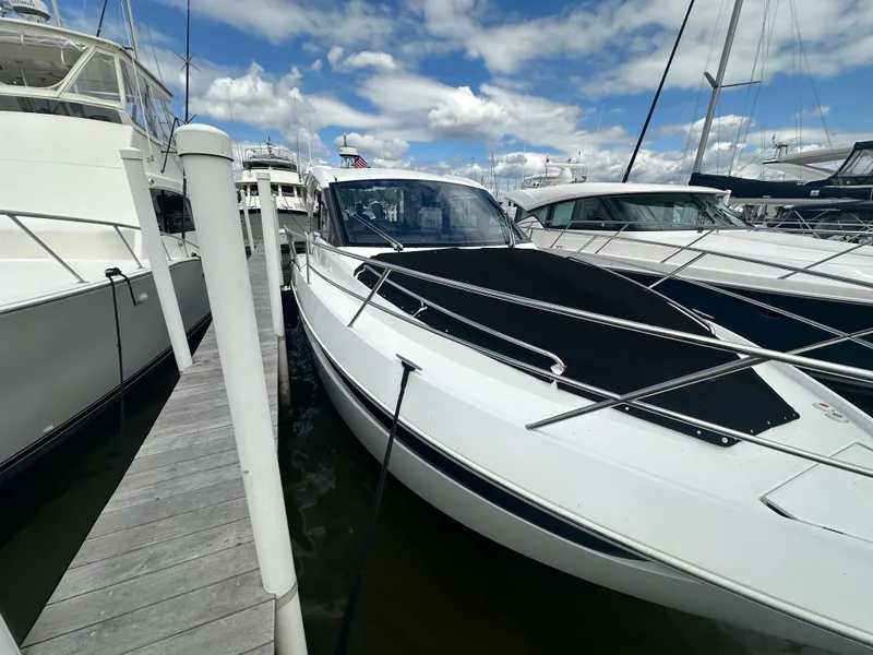 Slide: The Image of 2021 Galeon 425 HTS yacht docked at marina under blue sky. - 11