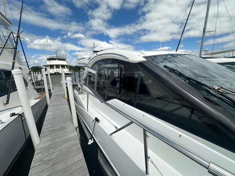 Slide: The Image of 2021 Galeon 425 HTS yacht docked at marina under blue sky. - 12