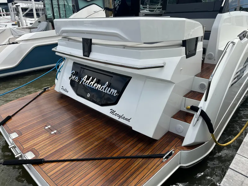 Slide: The Image of 2021 Galeon 425 HTS yacht docked, featuring sleek design and wooden deck. - 14