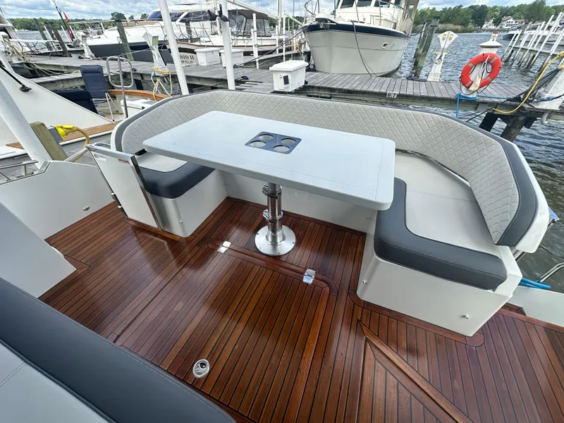 Slide: The Image of Luxury seating area on 2021 Galeon 425 HTS yacht with wooden deck and table. - 18