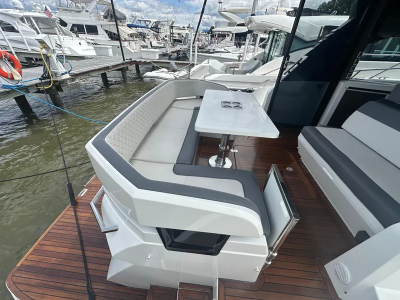 Slide: The Image of 2021 Galeon 425 HTS yacht with elegant outdoor seating and table on teak deck. - 19