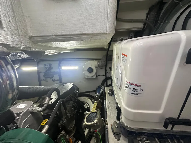 Slide: The Image of Engine room of 2021 Galeon 425 HTS yacht, showcasing mechanical components and equipment. - 28