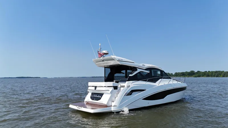Slide: The Image of 2021 Galeon 425 HTS yacht cruising on open water under clear blue sky. - 3