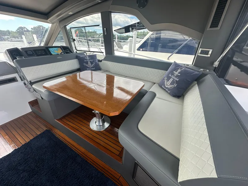 Slide: The Image of Interior of 2021 Galeon 425 HTS yacht with elegant seating and wooden table. - 33