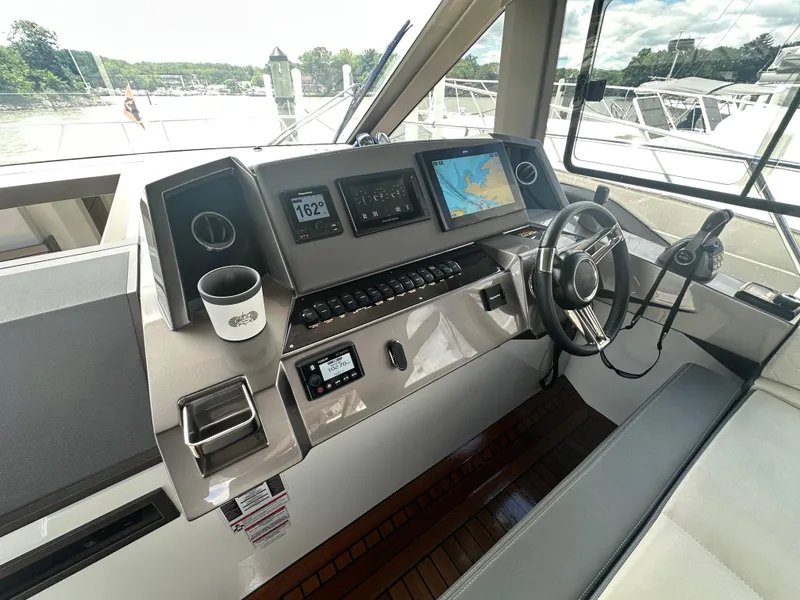 Slide: The Image of Helm of 2021 Galeon 425 HTS yacht with navigation screens and steering wheel. - 40